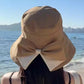 👒 💐 Women's Bowknot Wide Brim Sun Protective Hat – Oversized wide brim blocks UV rays, delicate bow decor, lightweight breathable fabric, ideal for beach, travel & outdoor walking✨