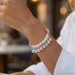 Verstelbare armband met zilveren belletjesbedeltje